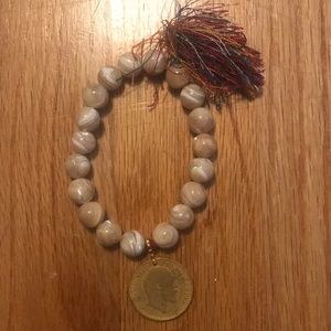 Creme bracelet with India coin & colorful tassels